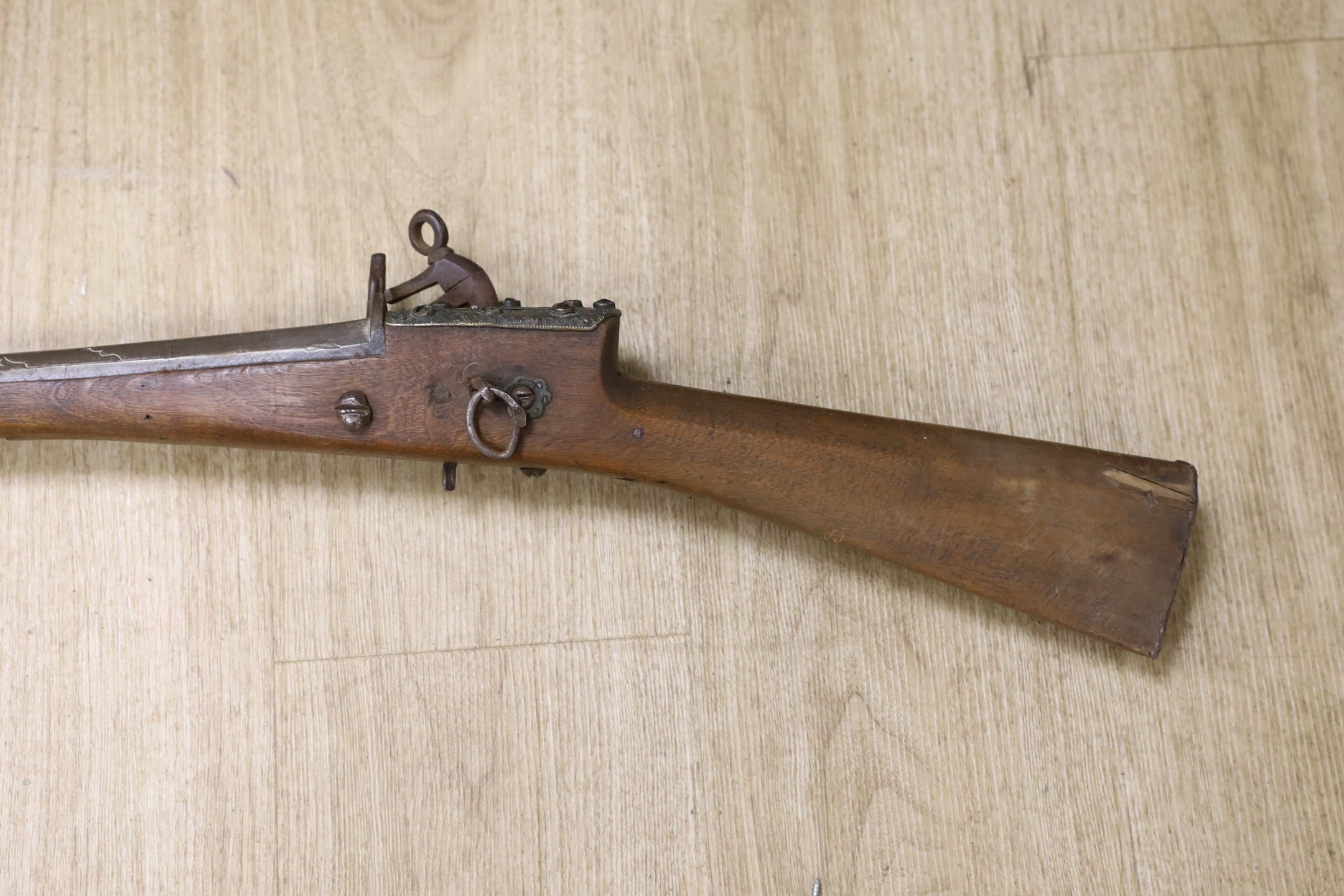 An Eastern decoratively metal mounted antique musket, 132cms long.